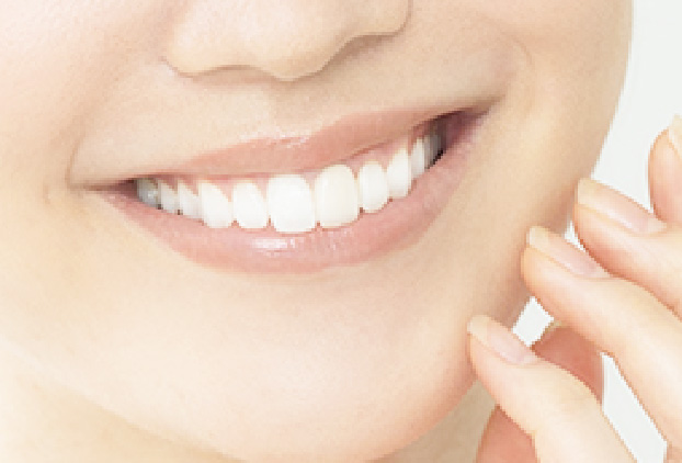 鏡で自分の歯を確認する女性